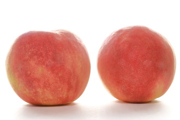 Ripe peaches on white background