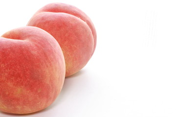 Ripe peaches on white background with copy space 