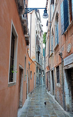 In Venice. View of a very narrow street between old houses