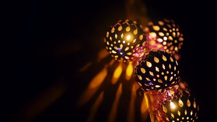 Magic lanterns spin and give beautiful glare to the walls. New Year glowing balls with led diodes are held in hands. Warm lamp light gives cosiness and christmas mood.