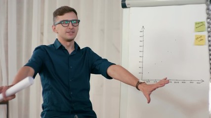 Hot Disscussion at Work: Business Man Team Leader or Trainer is Presenting Project to Employees in Loft Office. Seminar in Diverse Group of People. Meeting at Work. 4K Medium Gimbal Orbit Shot