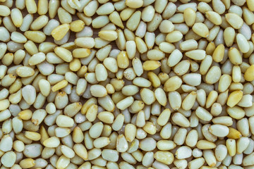 Background of peeled pine nuts without shell, top view