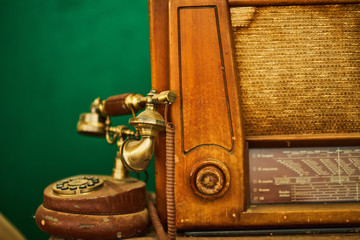 Vintage telephone, old retro radio on wood table