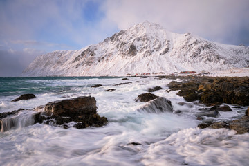 Coast of Norwegian sea on rocky coast in fjord on sunset