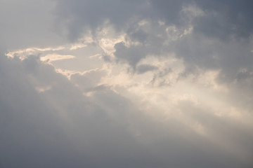 natural ray lights through white cloud on grey sky. foggy day from air pollution.