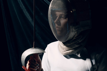 Fencer woman with fencing sword.