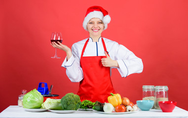 Best christmas recipes. Enjoy easy ideas for holiday parties and holiday dinners. Festive menu concept. Christmas dinner ideas. Christmas menu. No stress. Woman chef cooking wear santa hat drink wine