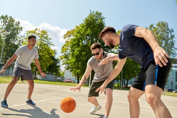 Poster sport, leisure games and male friendship concept - group of men or friends playing street basketball © Syda Productions
