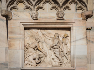 Fototapeta na wymiar Ornate facade of Milan Catehdral in Italy