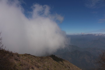 Fototapeta na wymiar a big cloud covering a mountain
