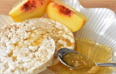 rice waffles with honey and slices of ripe peaches