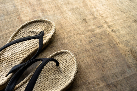 Vintage Cosy Sandal Or Slipper Is Placed On The Wooden Surface With Copy Space. Concept Photo To Take-off The Shoe For Relaxing Weekend-holiday.