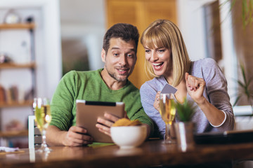Young couple shopping on internet with tablet