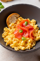Omelette with smoked salmon, scrambled eggs, tasty healthy breakfast with toast and fish. Morning food, seafood, organic food