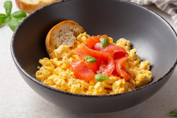 Omelette with smoked salmon, scrambled eggs, tasty healthy breakfast with toast and fish. Morning food, seafood, organic food