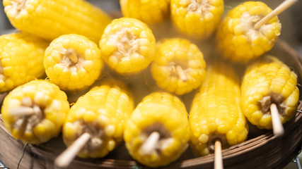 Many yellow corn kernels are sold in the street shops.
