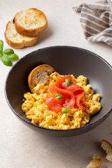 Omelette with smoked salmon, scrambled eggs, tasty healthy breakfast with toast and fish. Morning food, seafood, organic food