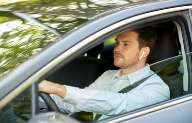 transport, vehicle and people concept - man or driver with wireless earphones or hands free device...