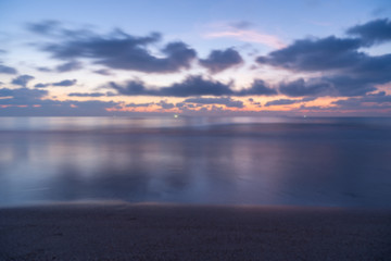 Fototapeta na wymiar Blurry blackground the beautiful landscape on sea with sunset blackground