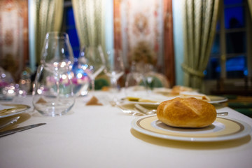 table in luxury hotel set for gala evening bread on a plate