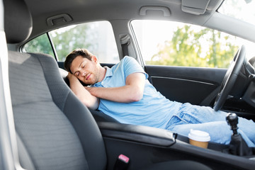 transport, rest and driving concept - tired man or driver sleeping in car - Powered by Adobe