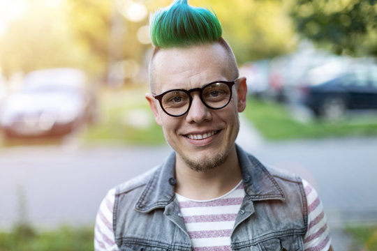 Portrait of a cool young man with pink mohawk