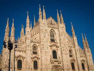 Fototapeta premium Ornate facade of Milan Catehdral in Italy at sunset