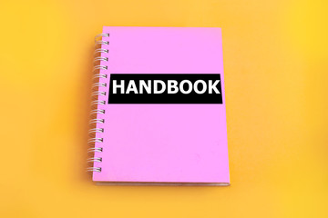 Pink handbook with yellow background - obrazy, fototapety, plakaty