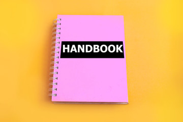 Pink handbook with yellow background