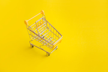 Shopping cart on yellow background