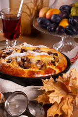 Fresh sweet fruit cake sprinkled with powdered sugar and cinnamon