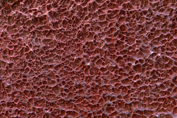 Texture of red clay plaster on the wall