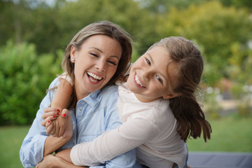 Naklejka premium Portrait of cheerful mother and daughter