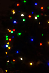 Naklejka na ściany i meble Christmas multi-colored lights on a black background, winter, bokeh, background
