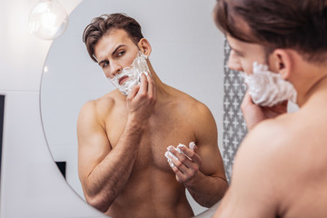 Confident man taking care of his face