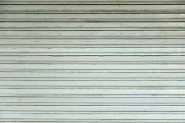 Naklejka premium An old light gray rolling steel door texture