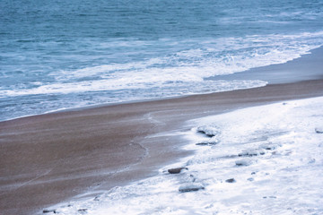 Snow covered beach during a snow storm in daylight