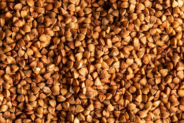 Buckwheat background, texture, the rump. Roasted buckwheat. Useful properties of buckwheat. Garnish.
