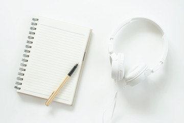 White headphones and a mocup book