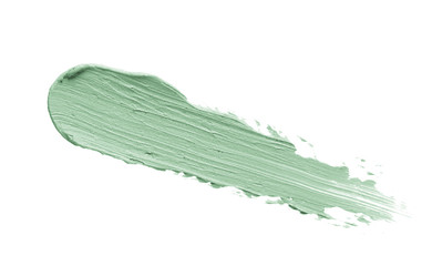 Color correcting concealer stroke isolated on white background. Mint green corrector cream smudge smear swatch sample. Makeup base foundation creamy texture