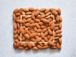 Almond nuts with square frame. Food background.