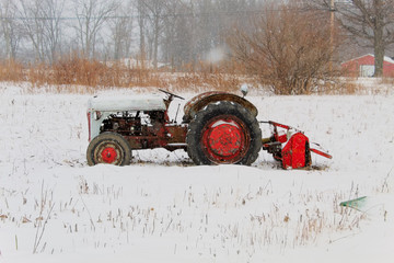 Antique Tractor With Snow Covered Background