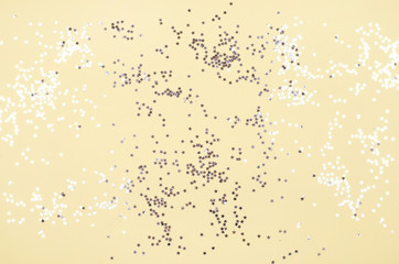 Yellow background with many small silver stars.