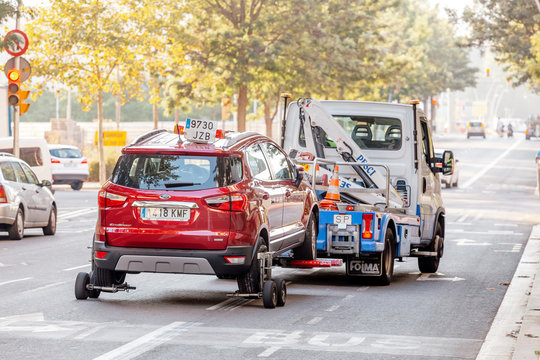 29 JULY 2018, BARCELONA, SPAIN: tow truck transporting car as punishment for wrong parking