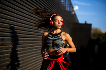 Young slim woman jogging in the dusk