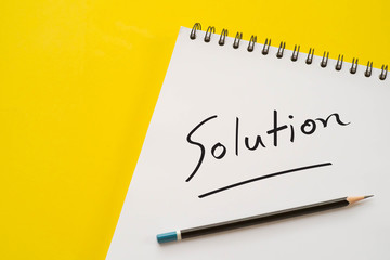 Notebook and pencil with Solution word