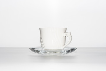 White cup and saucer on a white background