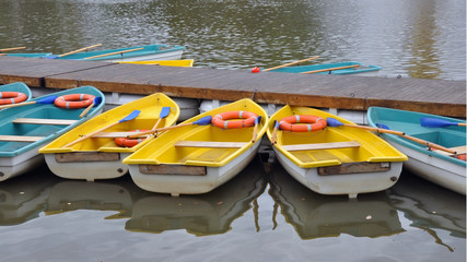 Rowing boats for water proglok at the pier on the lake in the park.