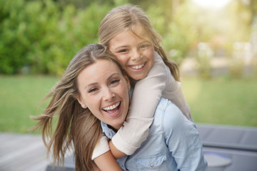 Fototapeta premium Portrait of cheerful mother and daughter