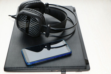 close up - computer and smart phone against wooden background